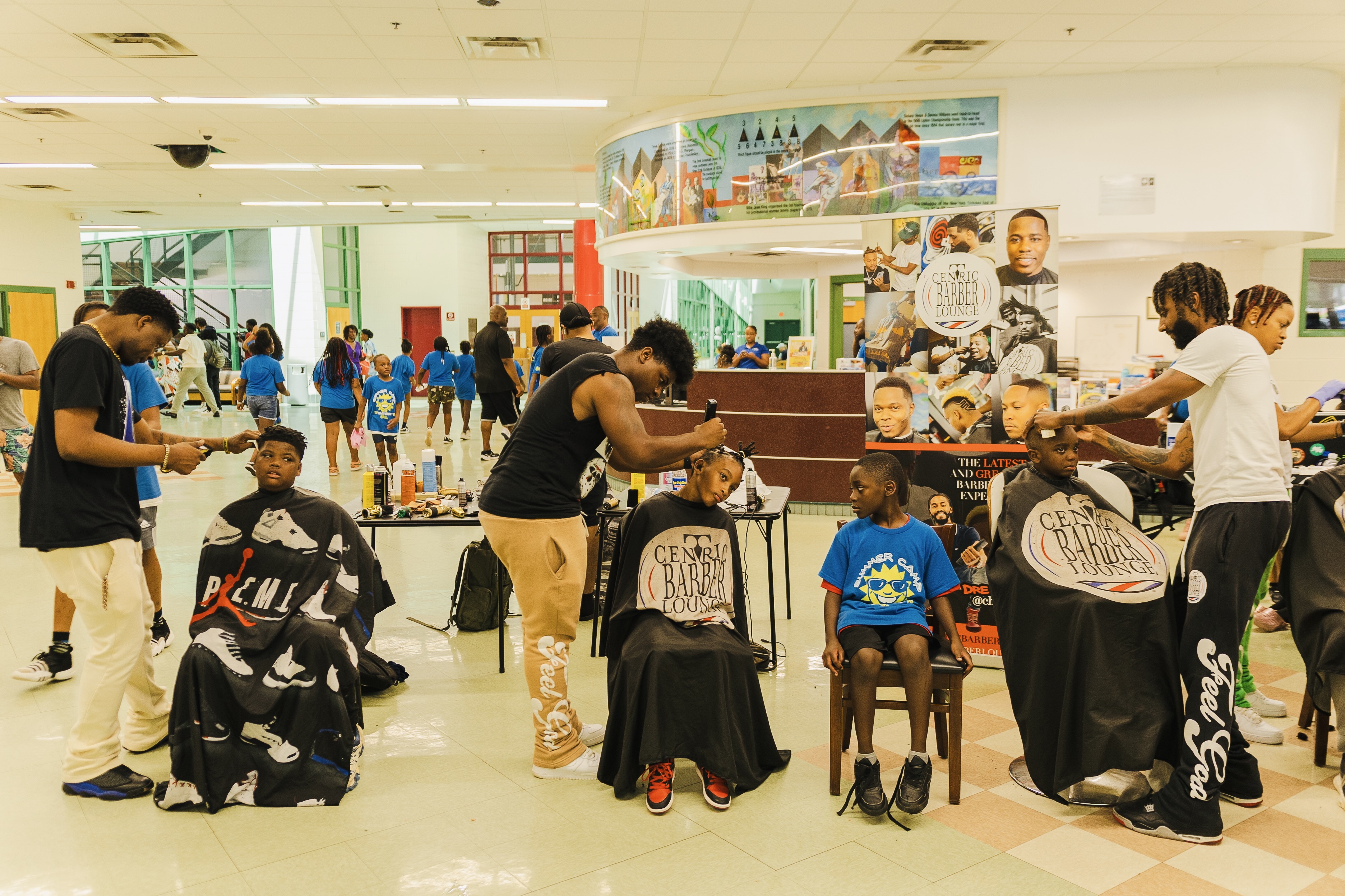Young men getting free haircuts at Turbo Day 2024